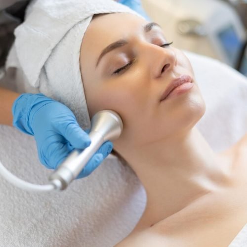 young-woman-lying-cosmetologist-s-table-rejuvenation-procedure-cosmetologist-take-care-about-neck-face-skin-youthfull-wellness-hardware-face-cleaning-procedure_343596-7877